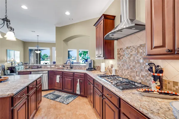 a bathroom with a granite countertop sink a toilet a mirror and shower