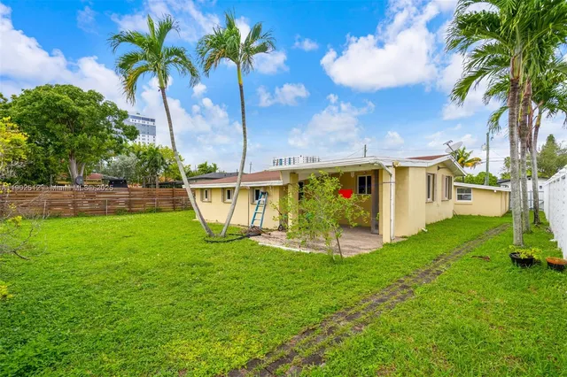 a view of a house with a yard and sitting area