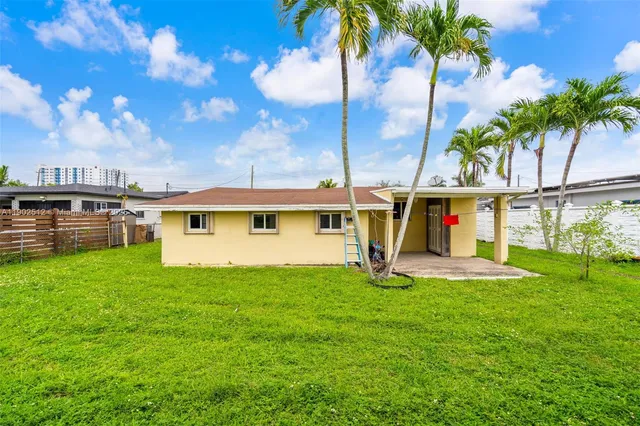 a view of a back yard of the house with a patio