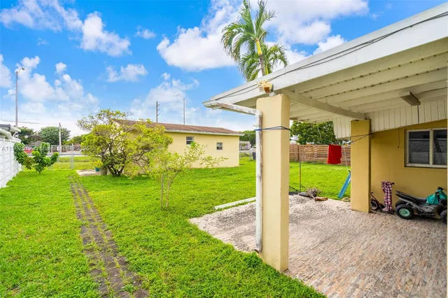 a view of a backyard with a garden and entertaining space