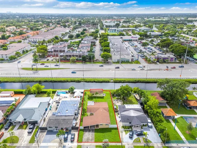 an aerial view of a house with outdoor space and a lake view