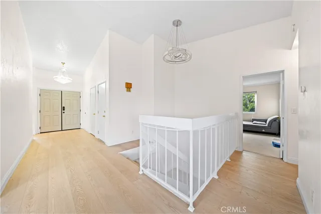 a view of a bedroom with wooden floor