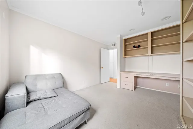 a bedroom with a bed and cabinet