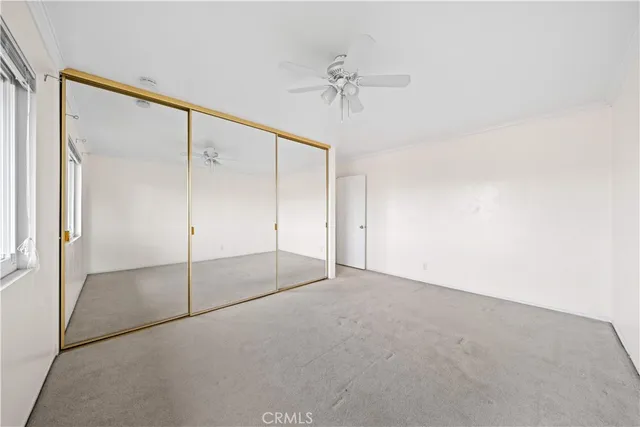 a view of an empty room with a fan