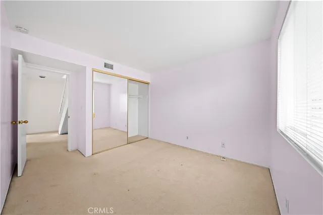 a view of a house with a yard and potted plants