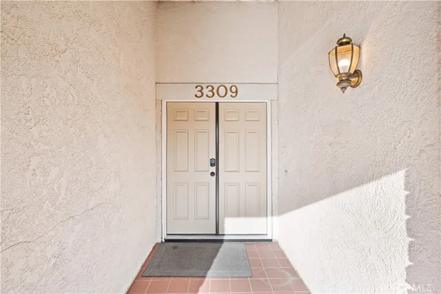 a view of a hallway with wooden floor and entryway