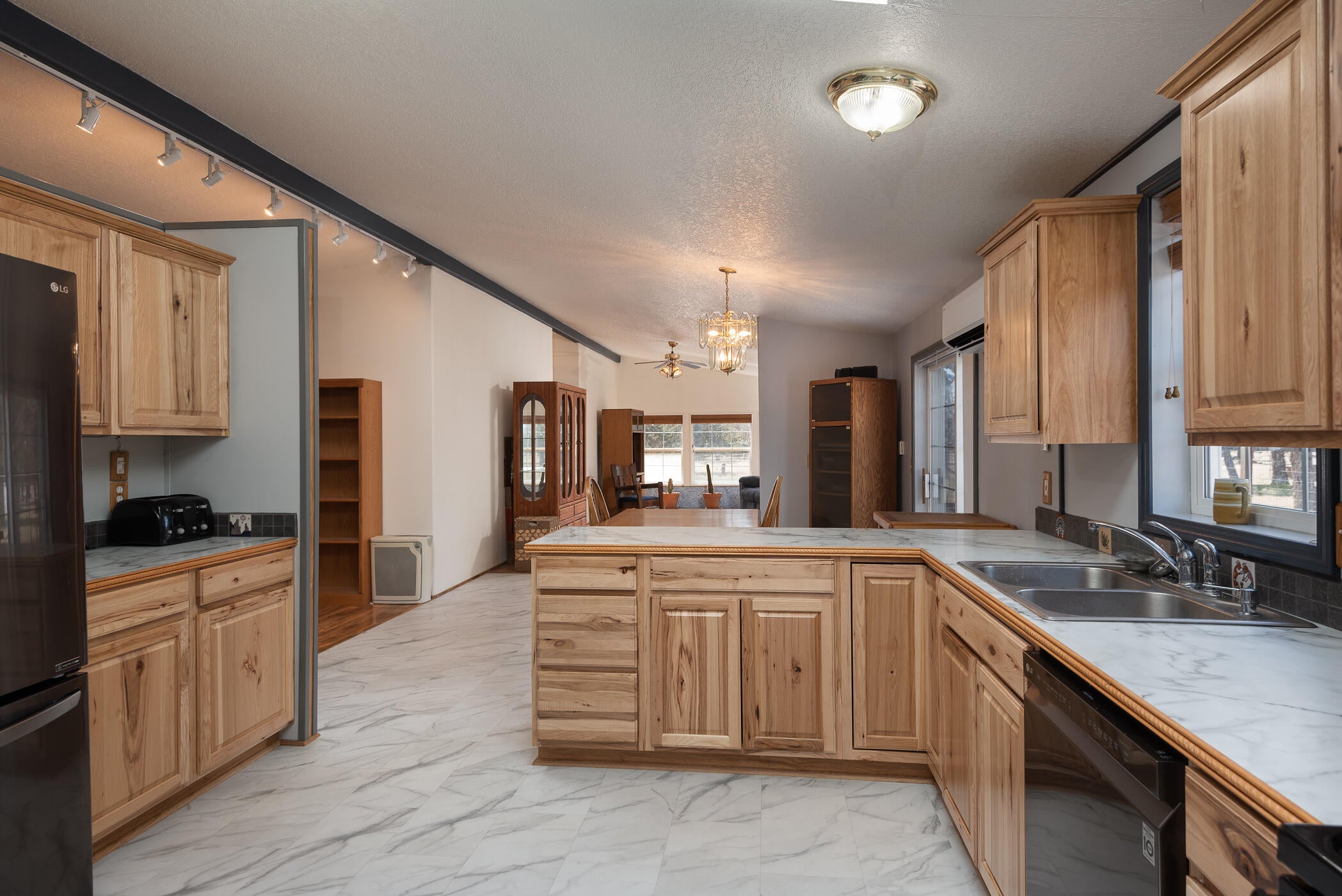 14638 Southwest Chickadee Road Terrebonne, OR 97760 - Photo 23 of 48 From Mud/Laundry Room through kitchen to dining and family room.