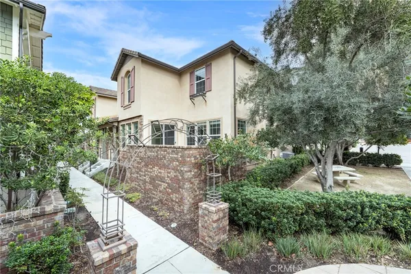 a front view of a house with a yard and shrubs
