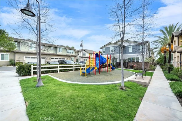 a view of kitchen with kitchen island stainless steel appliances wooden cabinets and window