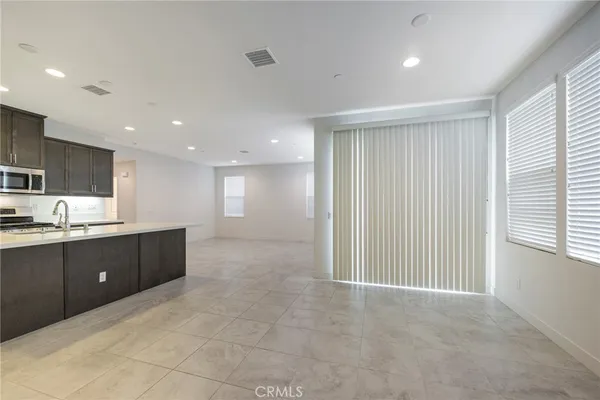 a kitchen with kitchen island granite countertop a sink and a stove