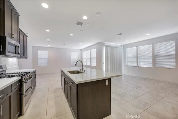 a kitchen with stainless steel appliances a stove and a microwave