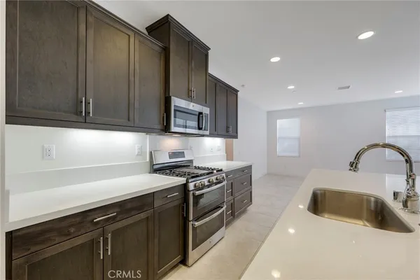 a large kitchen with stainless steel appliances granite countertop a large counter top and oven