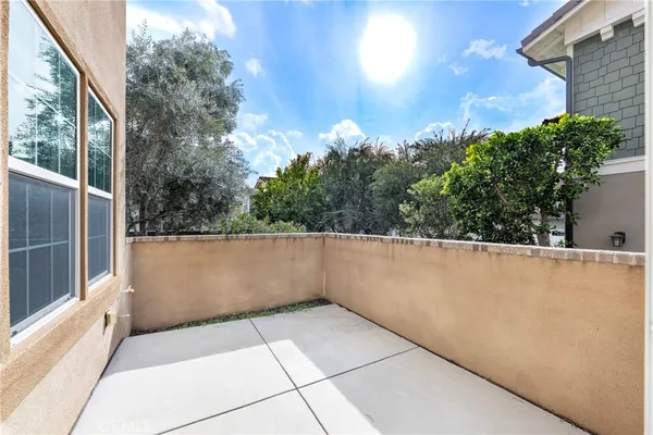 a view of a patio with table and chairs and potted plants