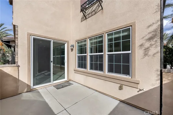 a view of a house with fountain plants and trees