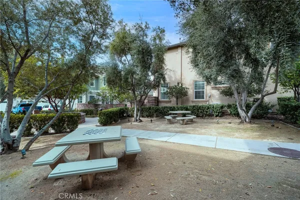 a view of a house with backyard sitting area and garden