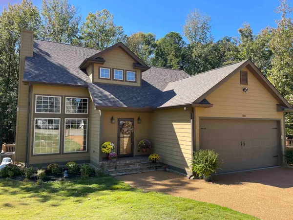 a front view of a house with a yard garage and outdoor seating
