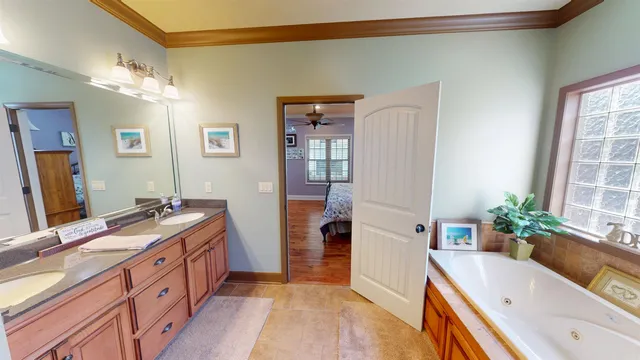 a bathroom with a tub sink and mirror