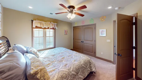 a bedroom with a bed and a chandelier