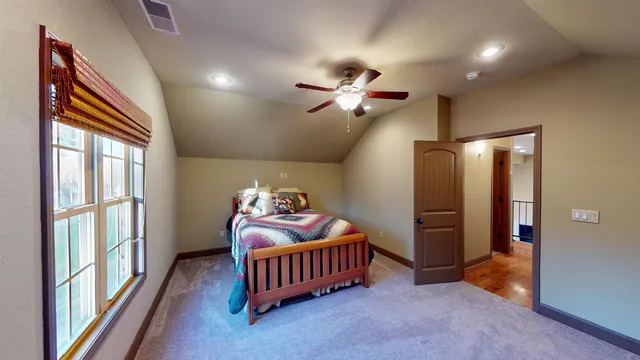 a bedroom with furniture and a window
