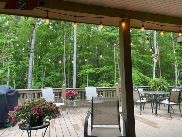 a house view with a seating space and a floor to ceiling window