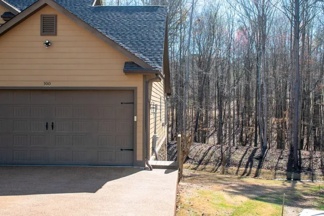 a view of house with backyard and outdoor seating