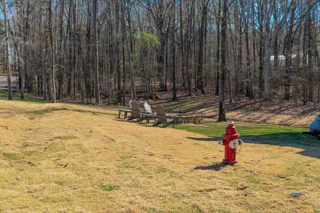 a backyard of a house with swimming pool table and chairs