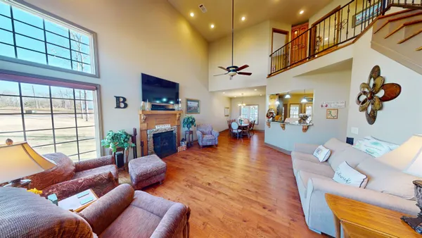 a living room with fireplace furniture and a flat screen tv