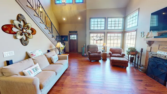a living room with fireplace furniture and a large window