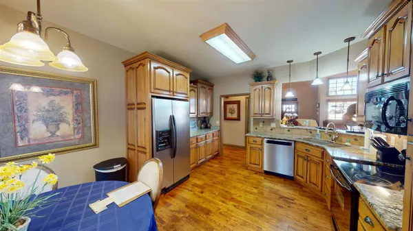 a kitchen with granite countertop lots of counter top space and stainless steel appliances