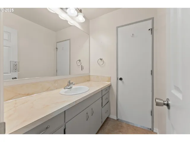 a bathroom with a sink a mirror and a shower