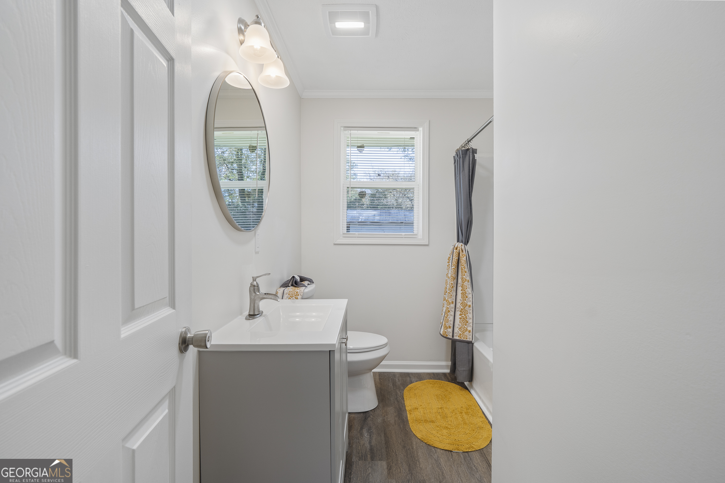 4622 Wilson Road Macon, GA 31206 - Photo 15 of 24 a bathroom with a toilet a sink and mirror