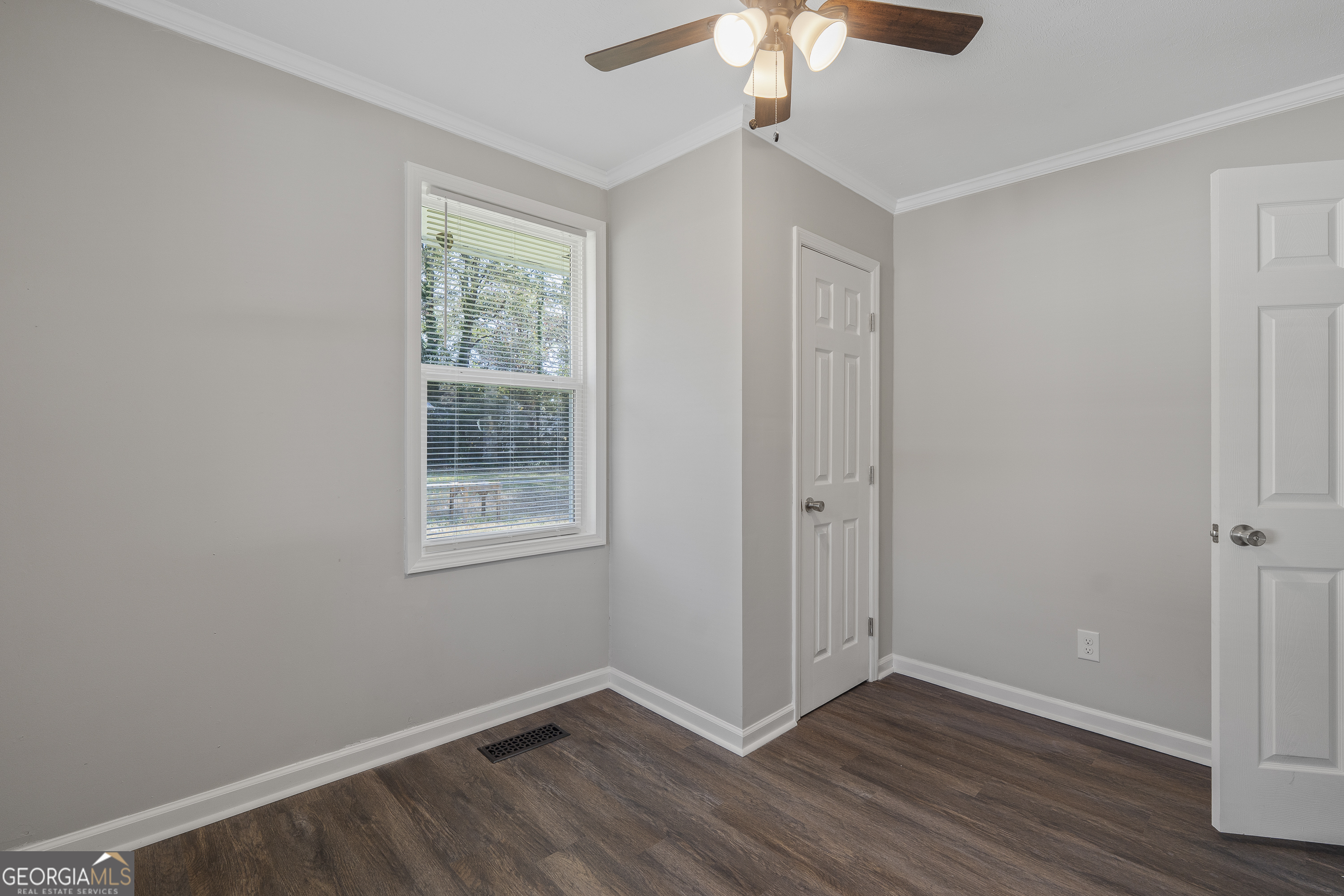 4622 Wilson Road Macon, GA 31206 - Photo 18 of 24 a view of an empty room with wooden floor and a window