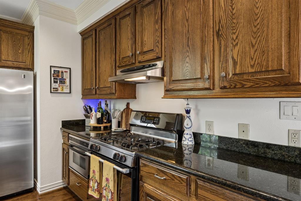 3101 Rosedale Avenue, Unit D University Park, TX 75205 - Photo 8 of 23 a kitchen with granite countertop cabinets and stove top oven