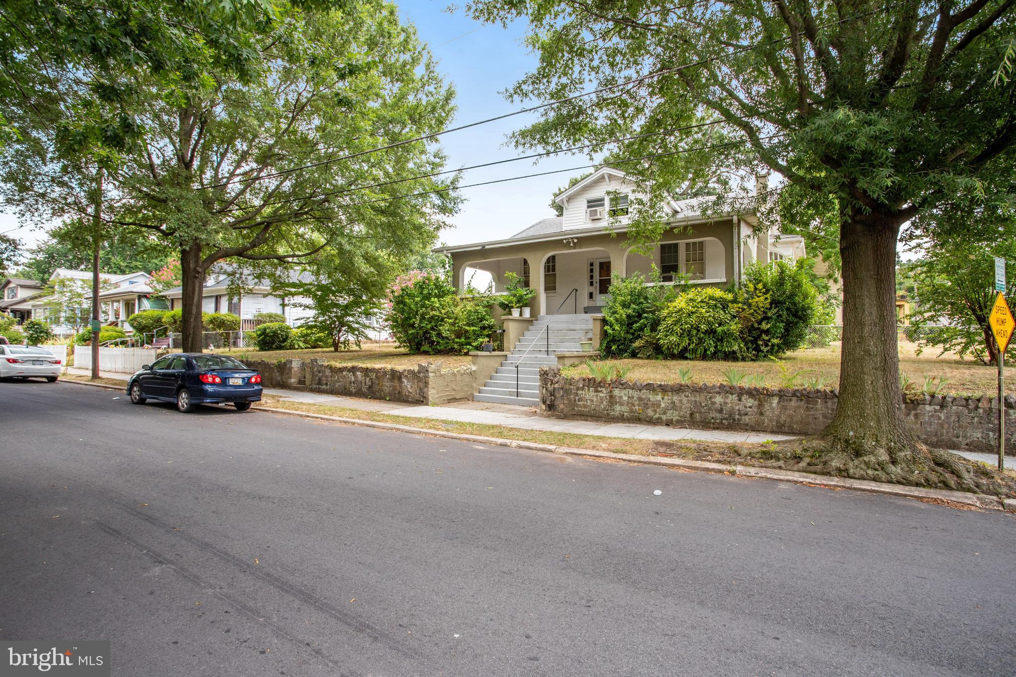 a view of a street with a car parked in front of it