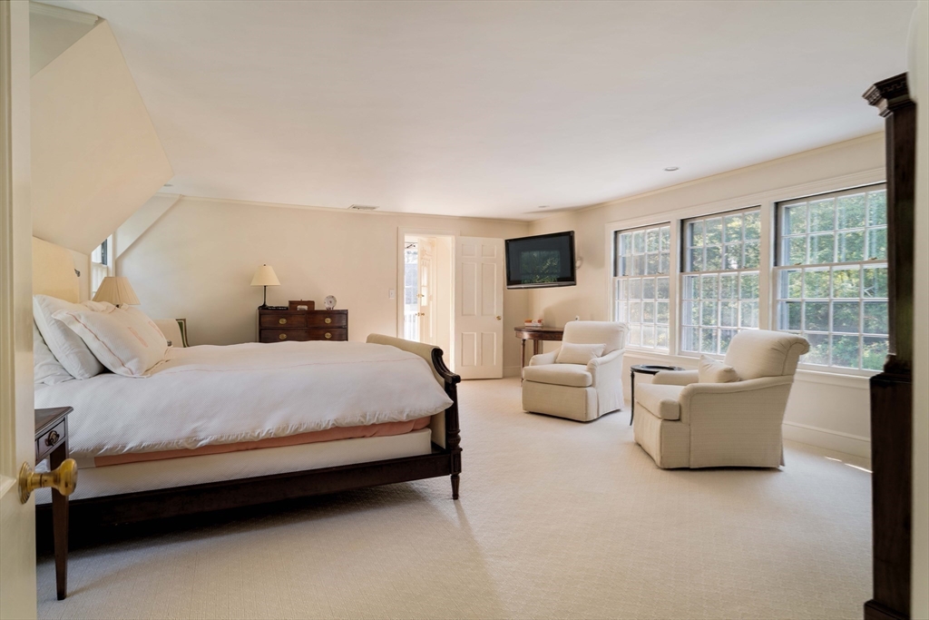 200 Cliff Road Wellesley, MA 02481 - Photo 25 of 41 a spacious bedroom with a bed and large windows