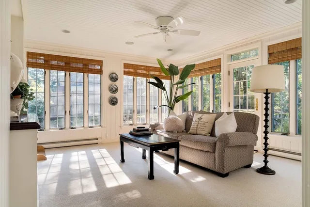 a spacious bedroom with a bed a couch and a large window