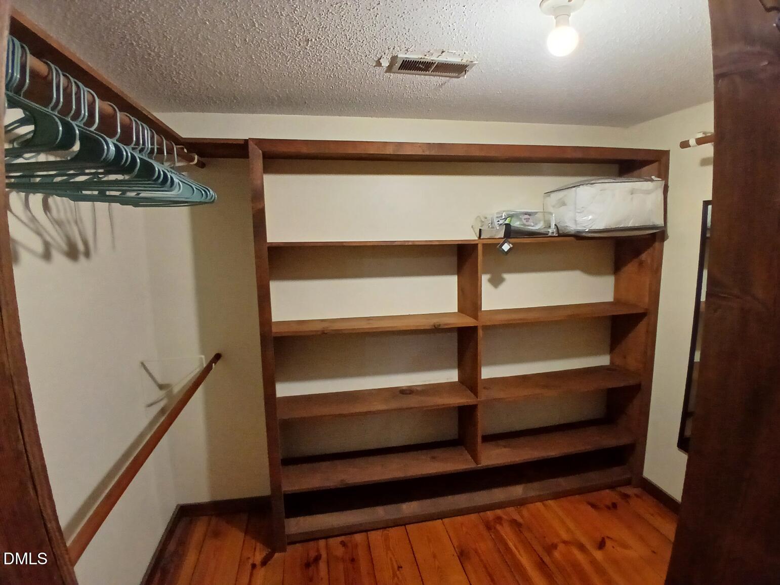 1920 Kelly Road Apex, NC 27502 - Photo 36 of 44 a view of walk in closet with empty racks