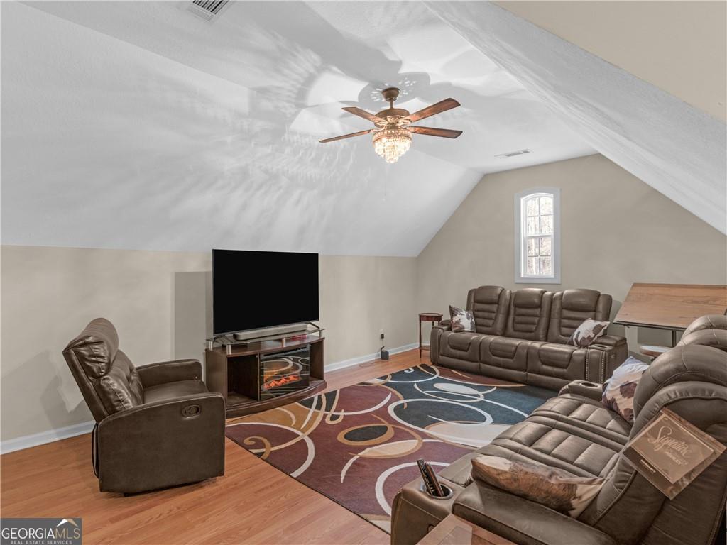 355 Parker Road Covington, GA 30014 - Photo 52 of 60 a living room with furniture and a flat screen tv