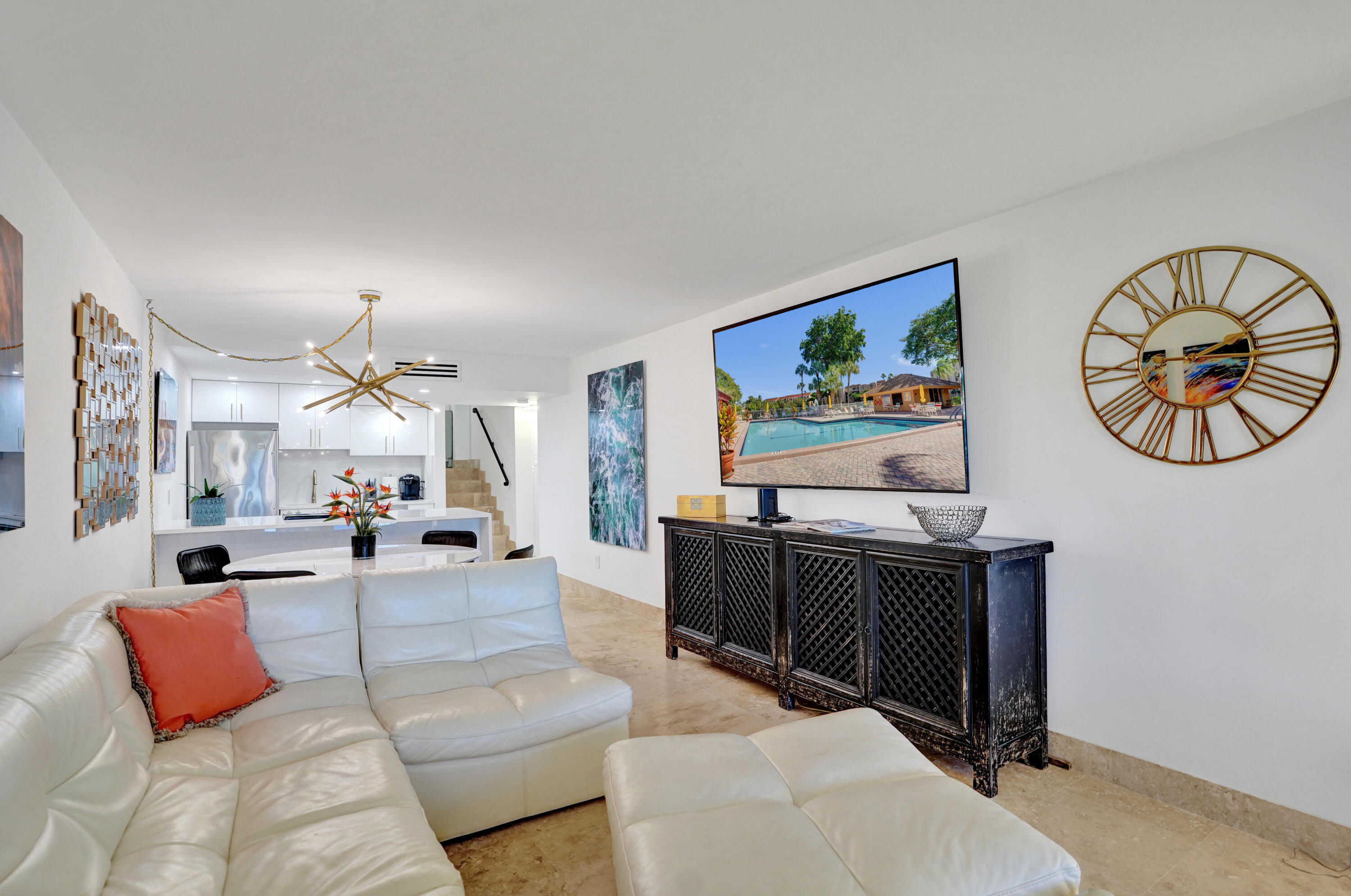 755 Dotterel Road, Unit 1112 Delray Beach, FL 33444 - Photo 15 of 64 a living room with furniture a rug and a chandelier