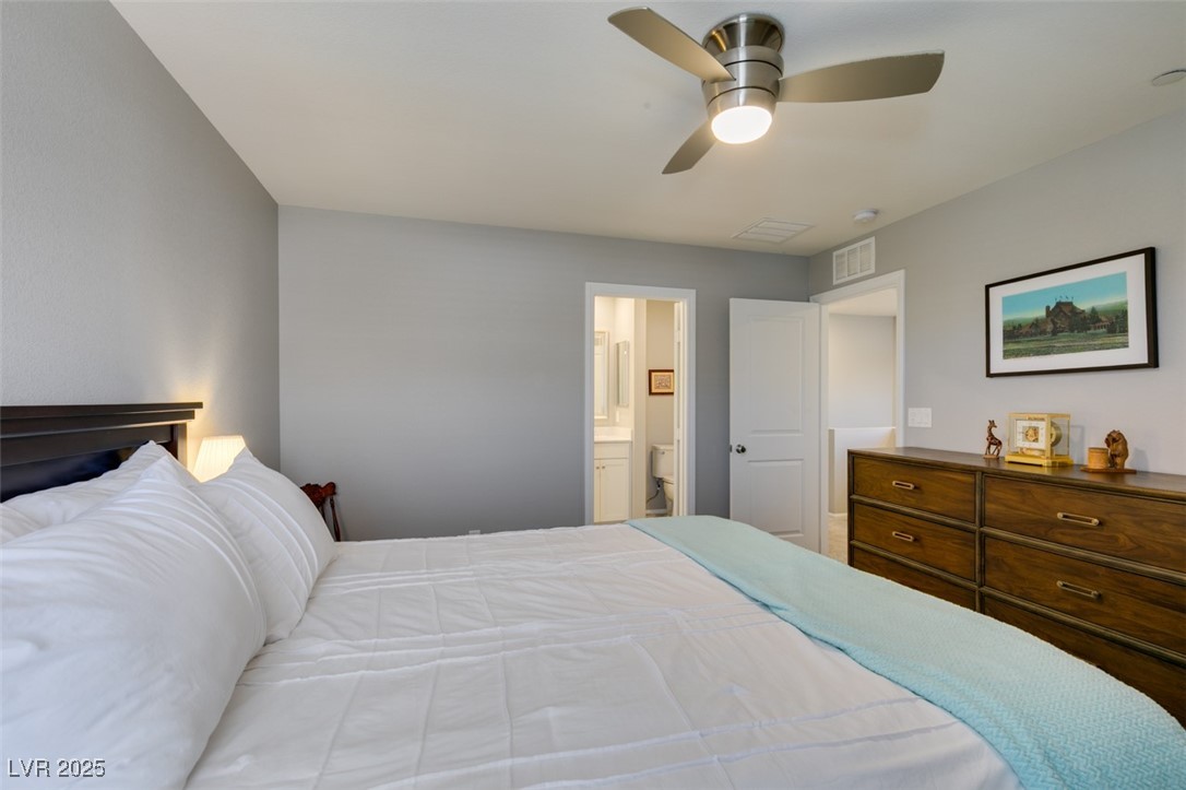 2870 Turnstone Ridge Street Henderson, NV 89044 - Photo 35 of 50 Bedroom with connected bathroom and ceiling fan