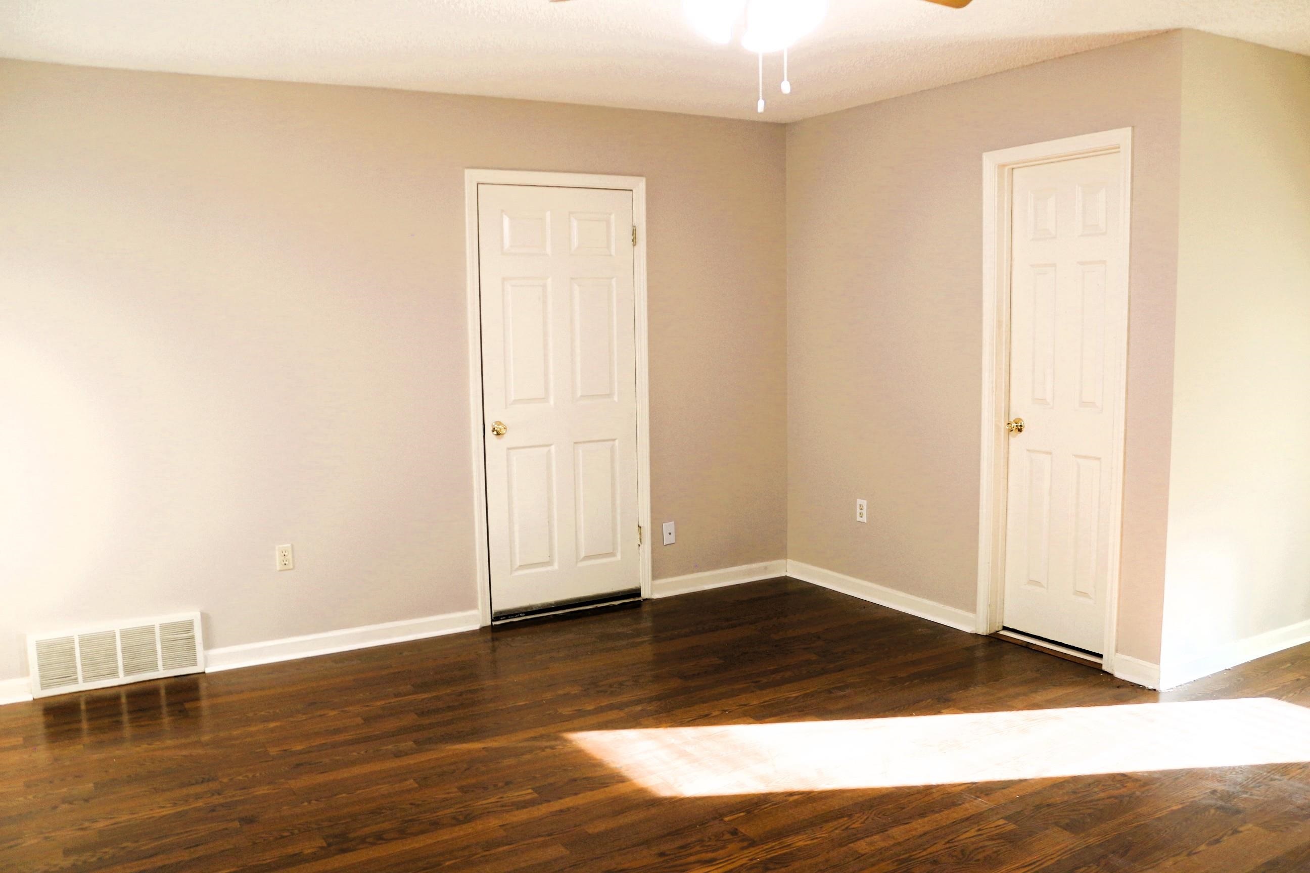 4204 Hickory Grove Road Memphis, TN 38141 - Photo 12 of 15 an empty room with wooden floor