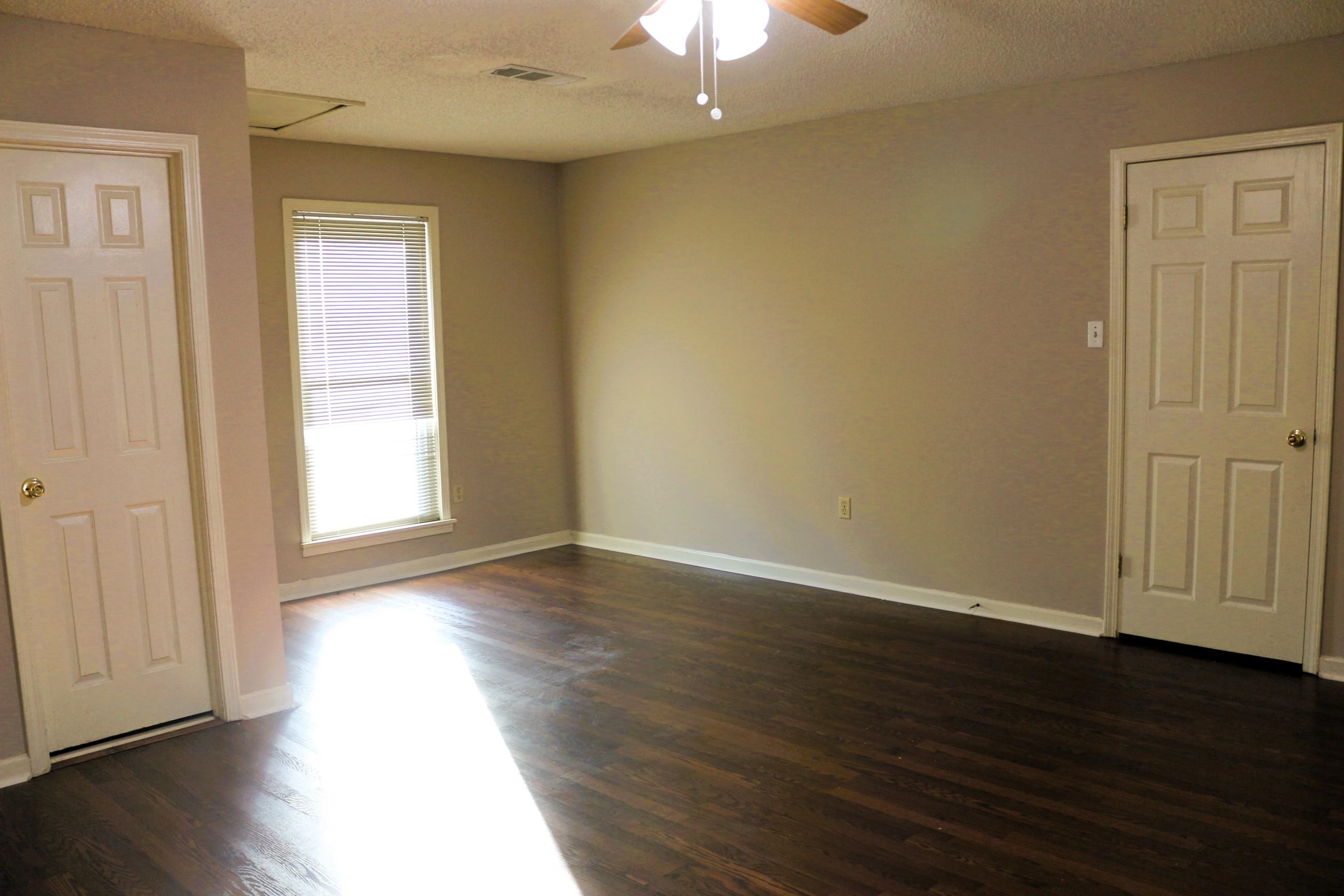 4204 Hickory Grove Road Memphis, TN 38141 - Photo 13 of 15 an empty room with wooden floor and windows