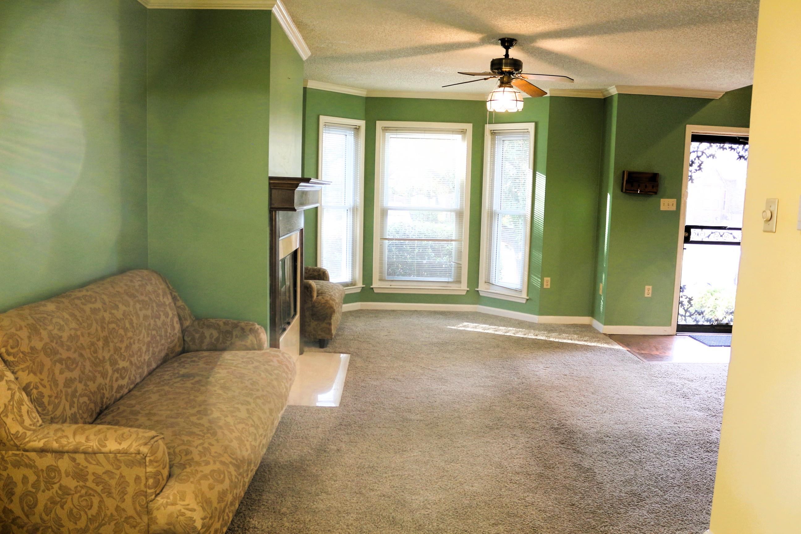 4204 Hickory Grove Road Memphis, TN 38141 - Photo 5 of 15 a living room with furniture and a chandelier