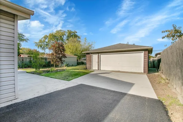 a view of a house with a yard and garage