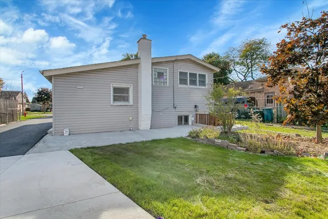a front view of a house with a garden and yard