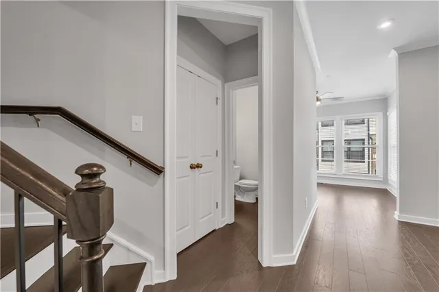 a view of a hallway with wooden floor and entryway
