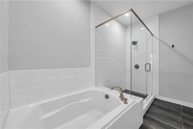 a bathroom with a bathtub and shower