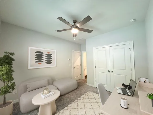a living room with furniture and a potted plant