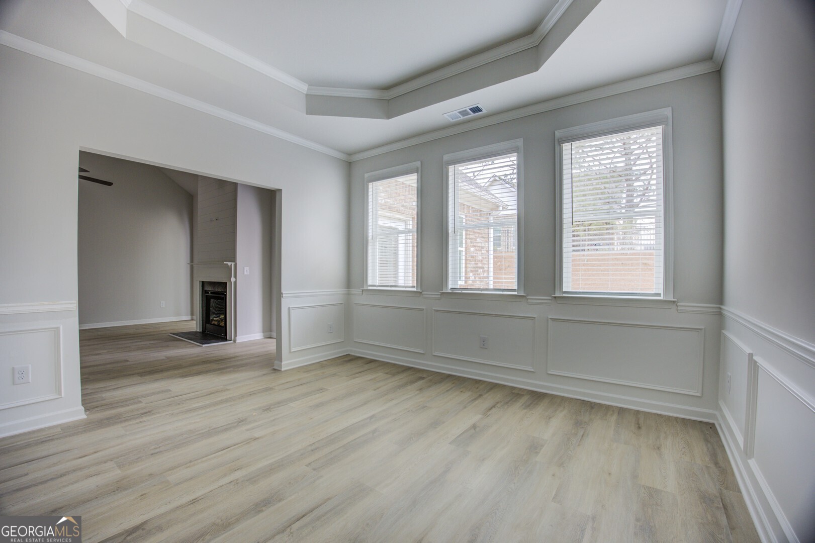 1007 Towne Circle Social Circle, GA 30025 - Photo 19 of 48 a view of an empty room with wooden floor and a window