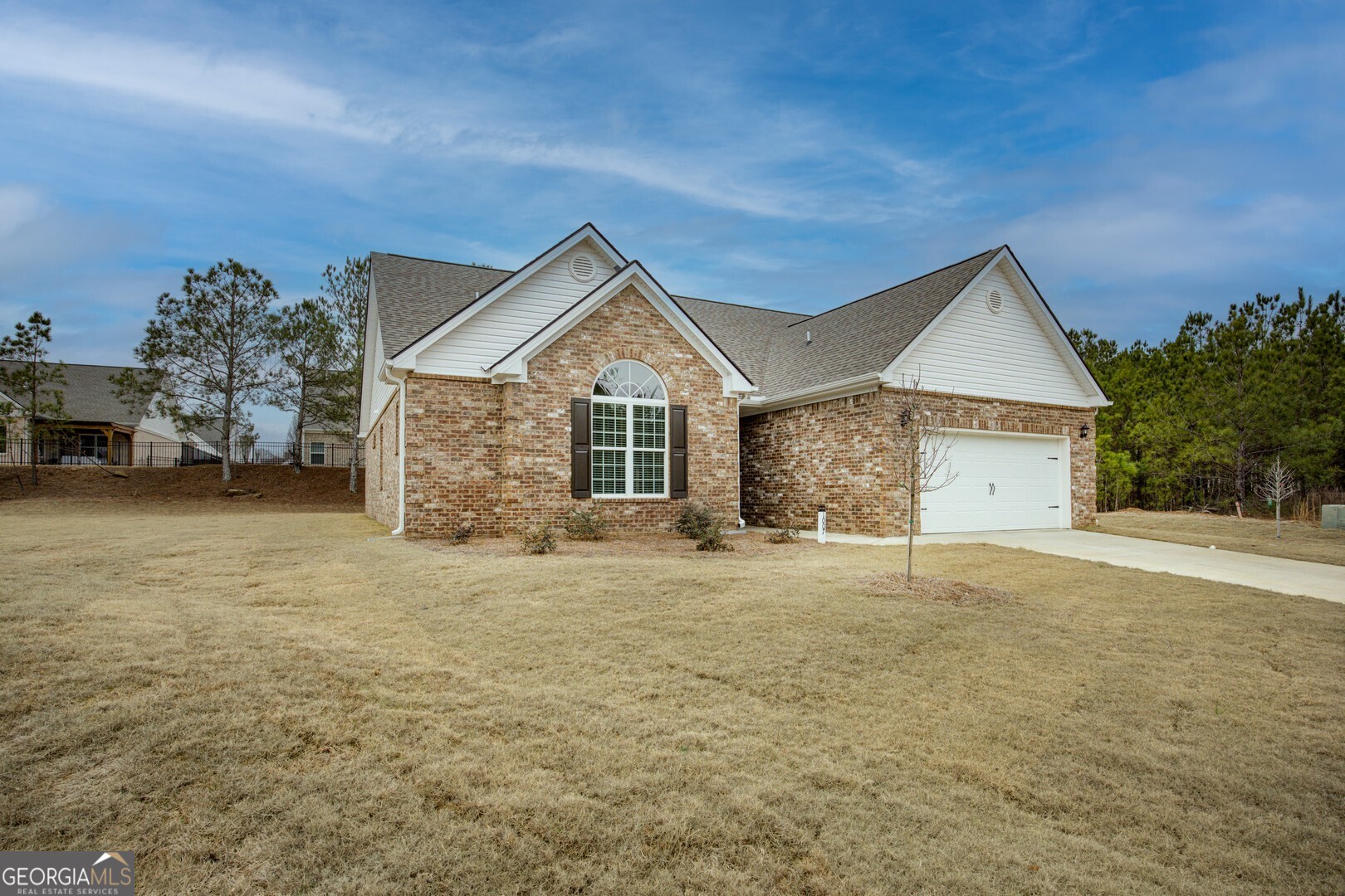 1007 Towne Circle Social Circle, GA 30025 - Photo 2 of 48 a front view of a house with a yard and garage